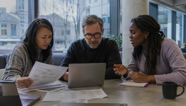 Canadian workers reviewing a changing digital workflow in a modern workplace