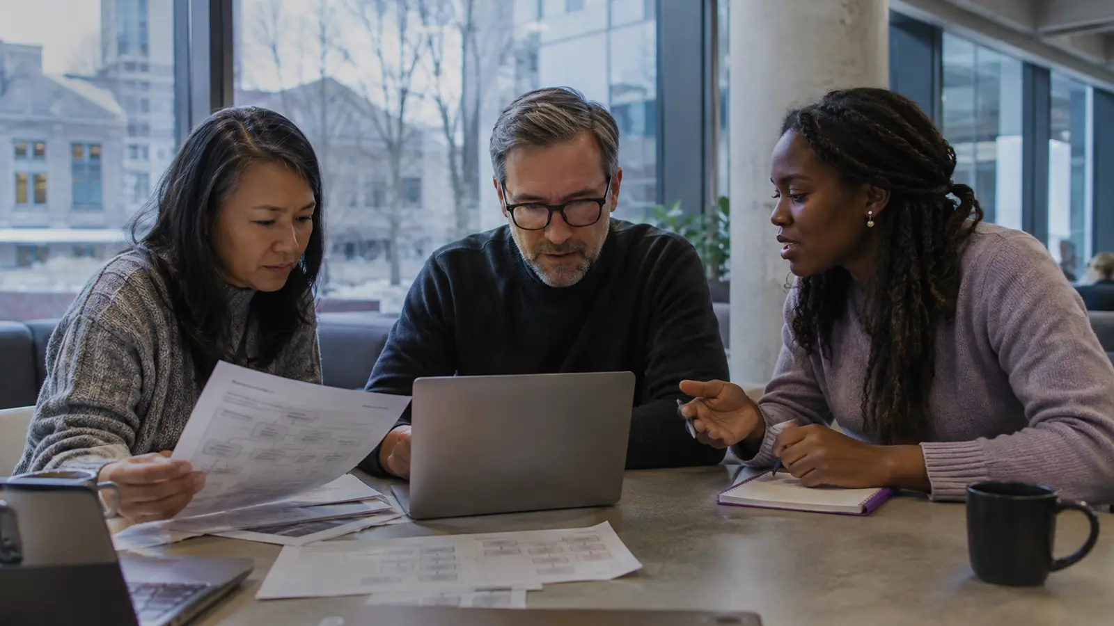 Canadian workers reviewing a changing digital workflow in a modern workplace