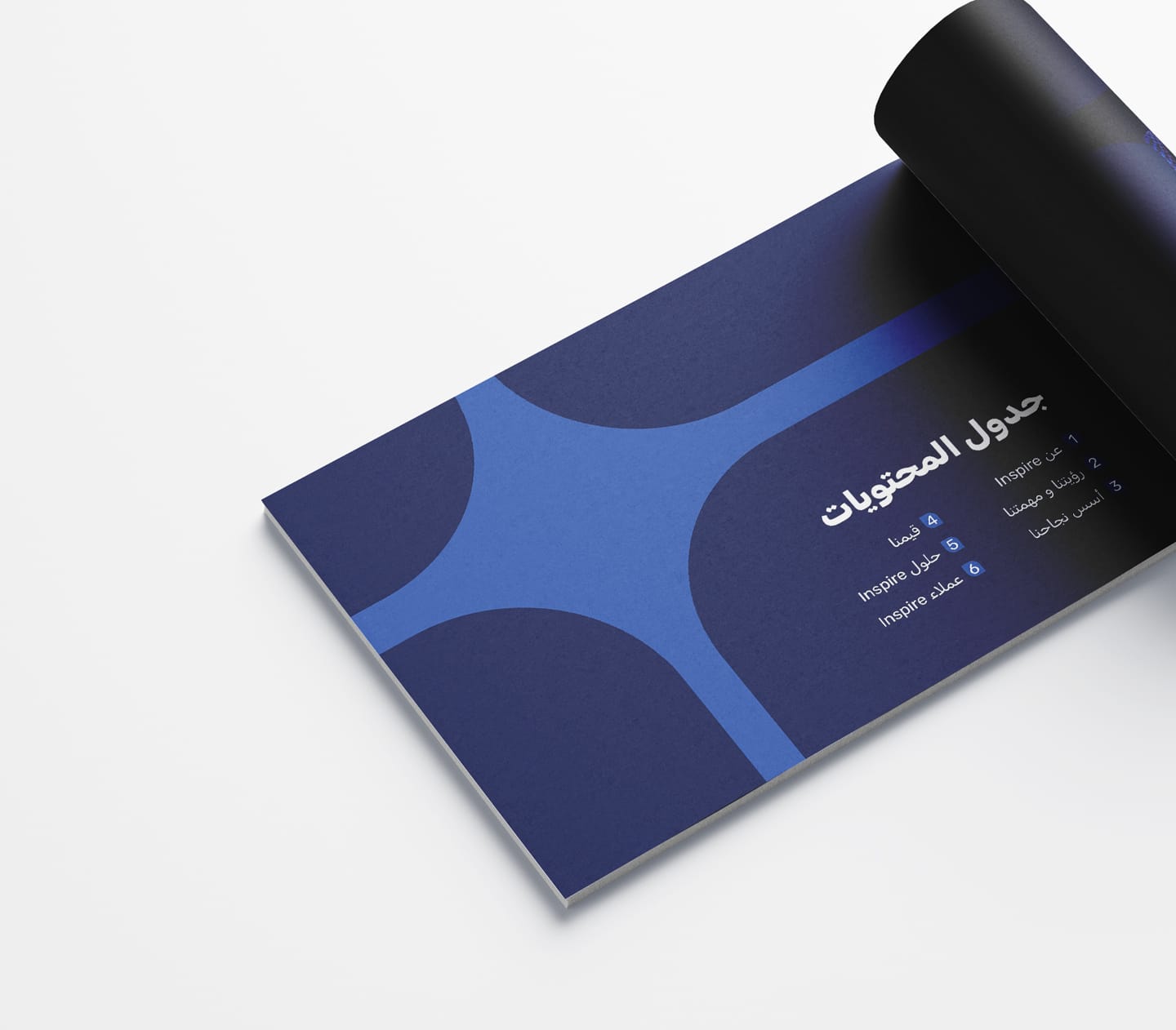 Inspire company profile mockup showing the Arabic table of contents page with the brand’s blue graphic system.