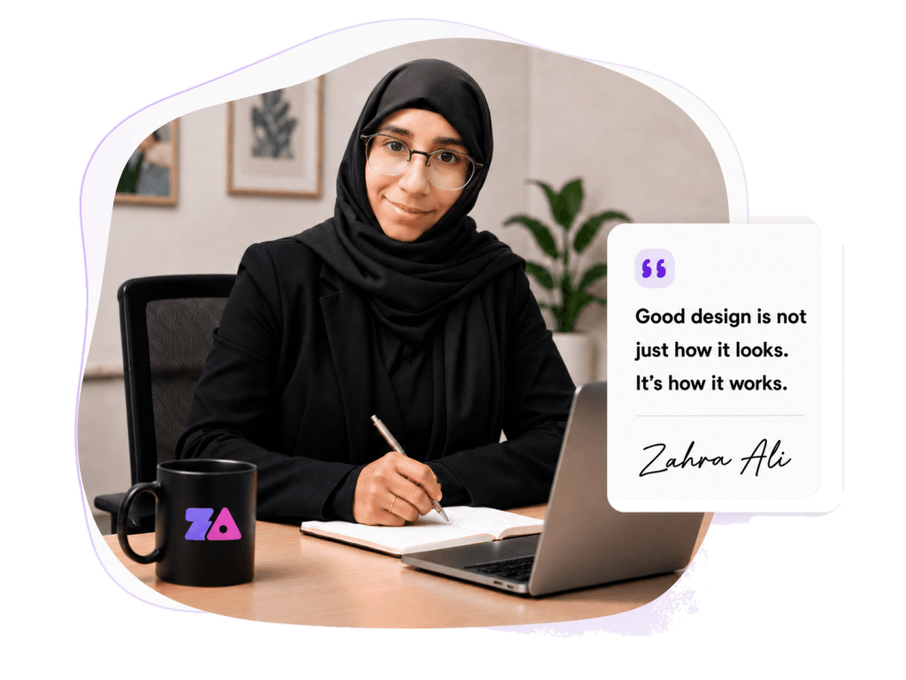 Zahra Ali working at her desk with a laptop, branded mug and design quote card