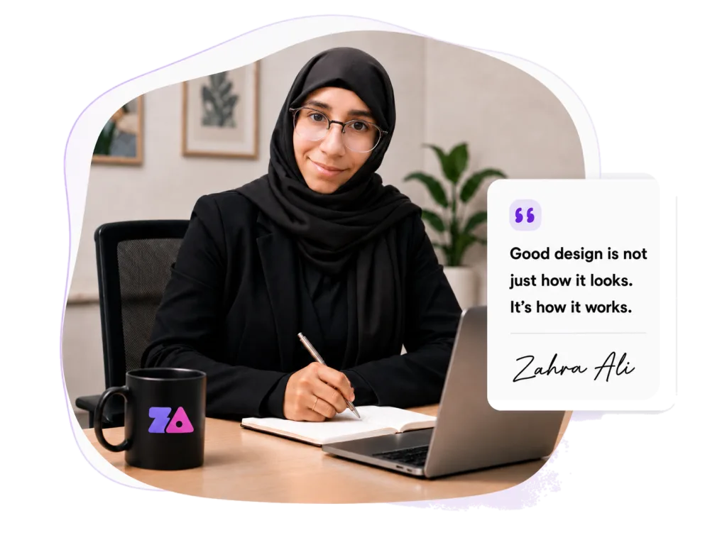Zahra Ali working at her desk with a laptop, branded mug and design quote card